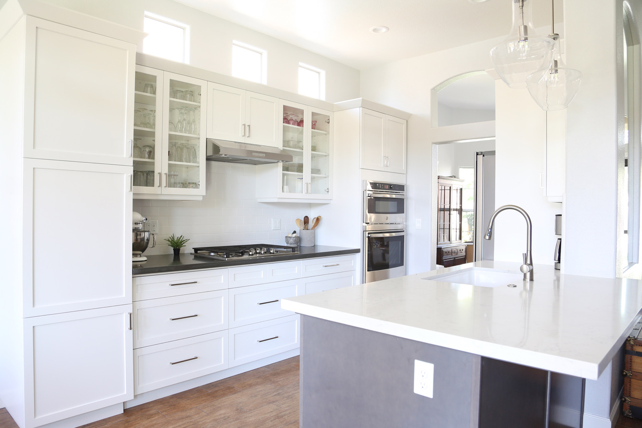 an island counter top and kitchen stove