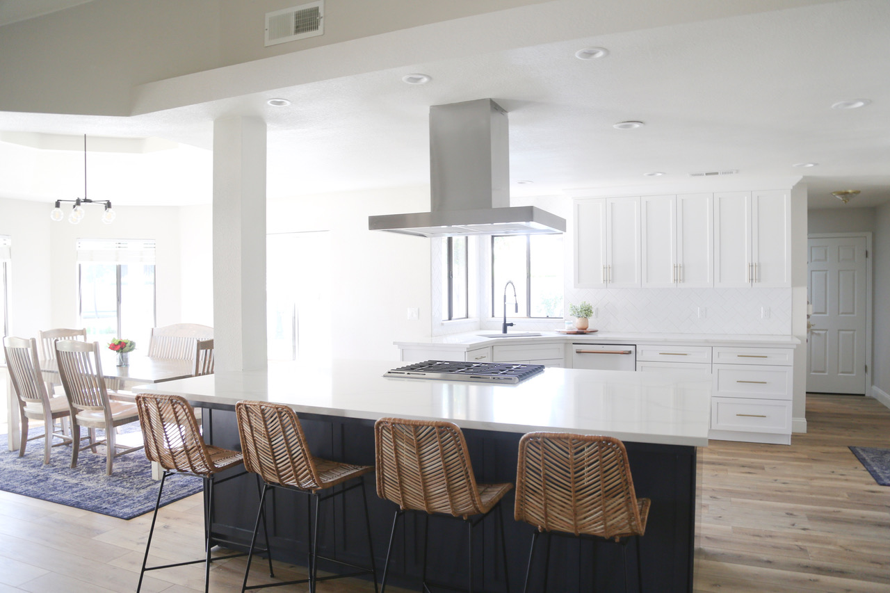 an island counter top with chairs