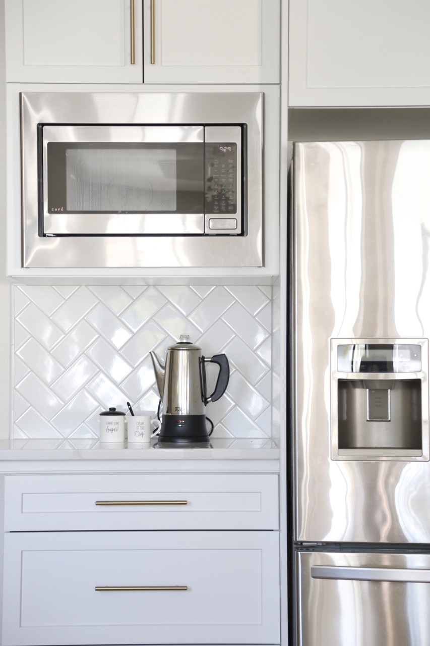 a closeup of white tile under a microwave