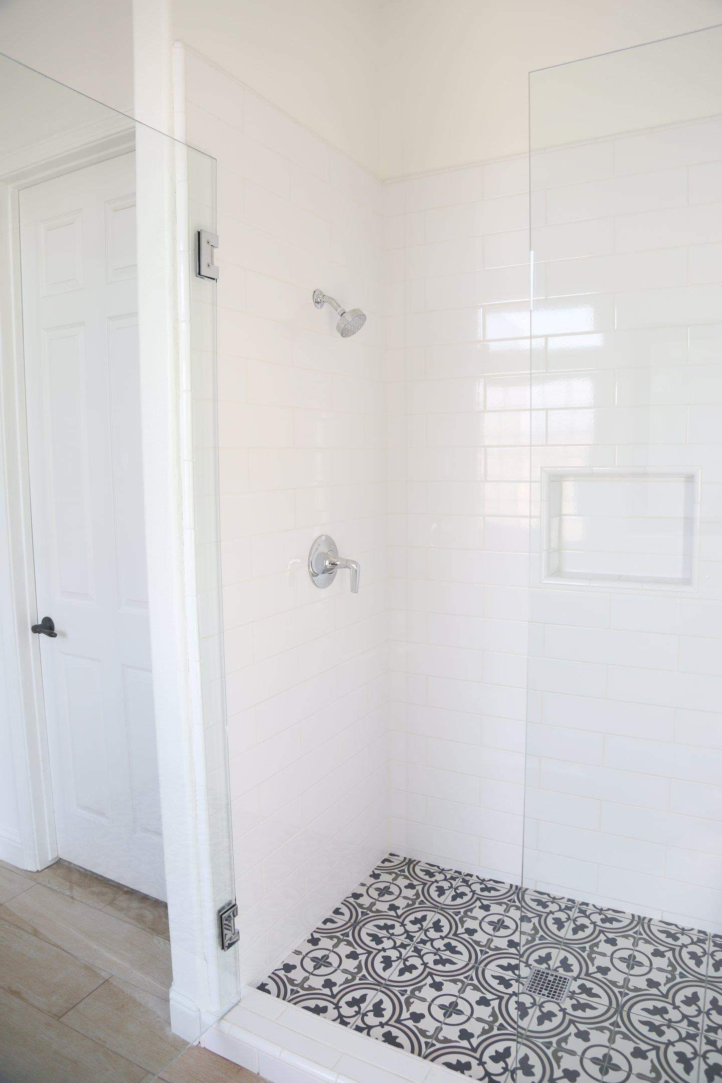 a tile shower in a bathroom